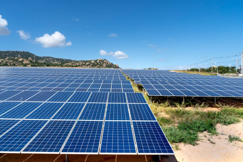 pexels-photo-6876537 A vast field of solar panels harnessing solar energy on a sunny day.